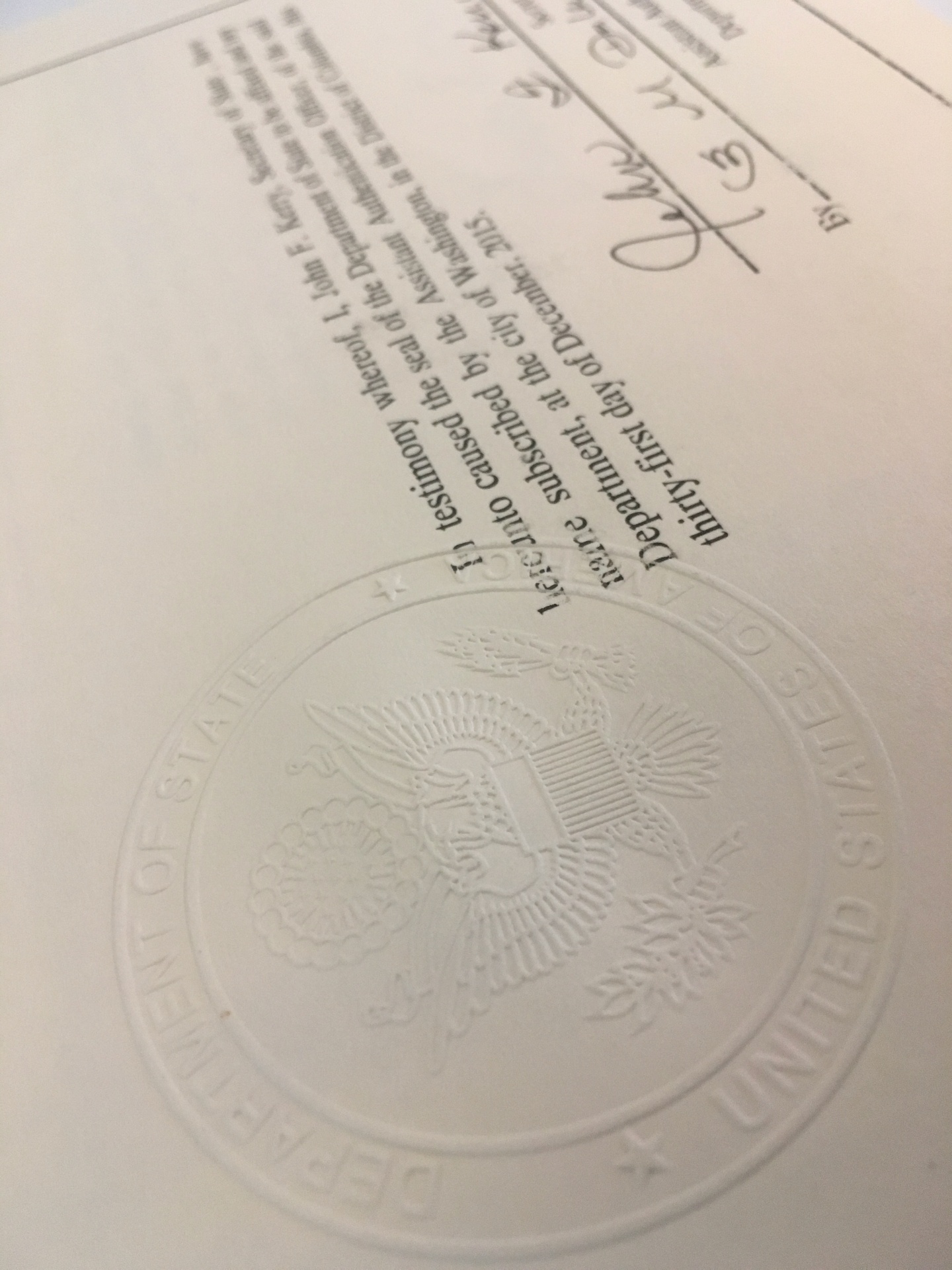 Great Seal embossment over the testimony clause — detail.